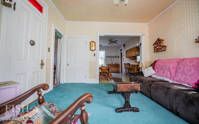 living room featuring carpet, ceiling fan, and crown molding