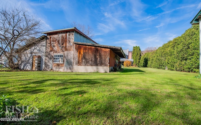 rear view of property featuring a lawn