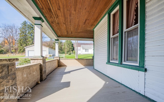 view of patio / terrace with an outdoor structure and a porch