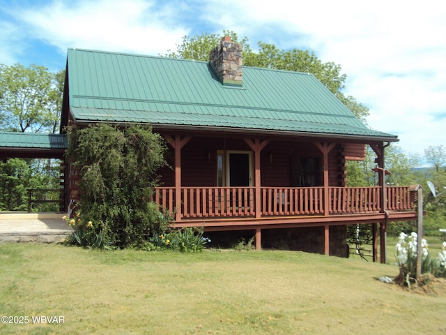 70 Berry Ln, Mill Hall, PA 17751 - view of front facade with a front yard, a chimney, a standing seam roof, and log siding