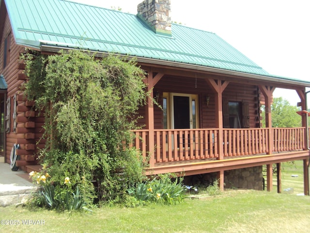 70 Berry Ln, Mill Hall, PA 17751 - back of property with a standing seam roof, log exterior, a chimney, covered porch, and metal roof