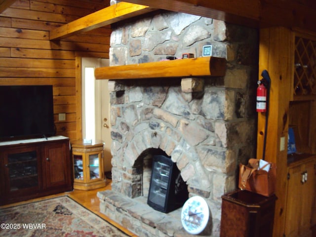 70 Berry Ln, Mill Hall, PA 17751 - living room with beam ceiling, wood walls, a fireplace, and wood finished floors