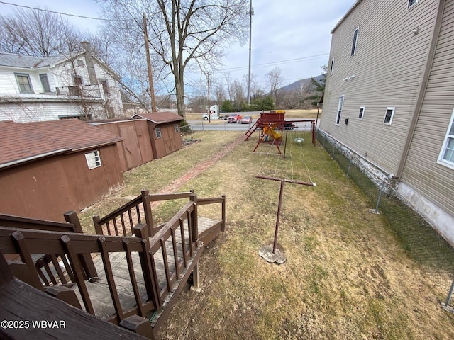 view of yard with an outdoor structure and a playground