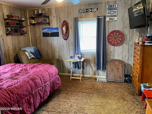 carpeted bedroom featuring visible vents and wood walls