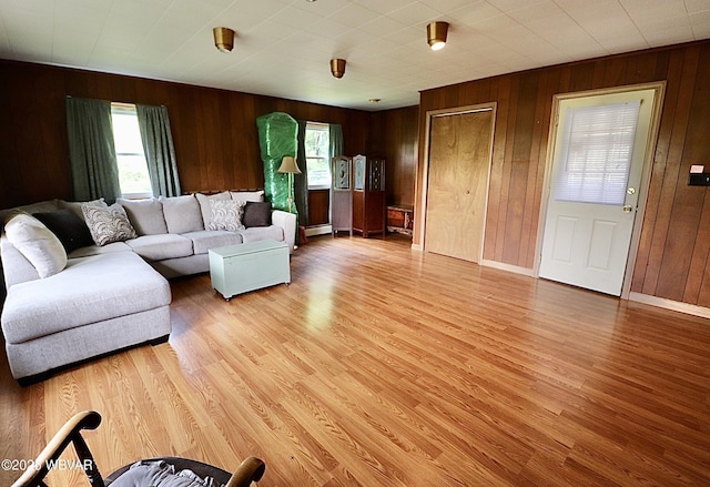 1964 Poco Farm Rd, Williamsport, PA 17701 - living room with light wood-style floors, wooden walls, baseboard heating, and baseboards