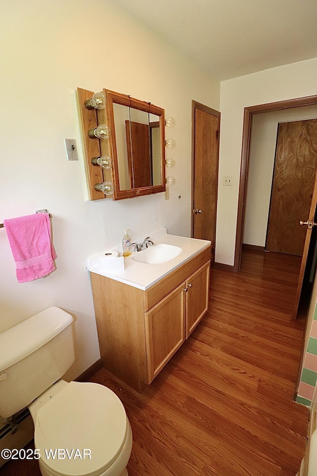 1964 Poco Farm Rd, Williamsport, PA 17701 - bathroom featuring wood finished floors, vanity, toilet, and baseboards