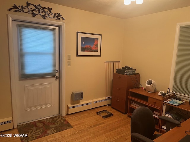 office featuring light wood-style floors and a baseboard radiator
