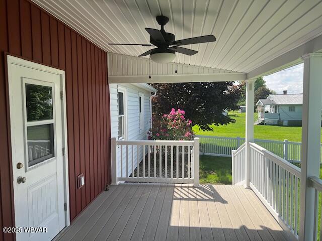 deck featuring ceiling fan and a lawn