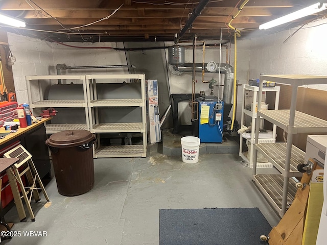 unfinished basement with concrete block wall and a heating unit
