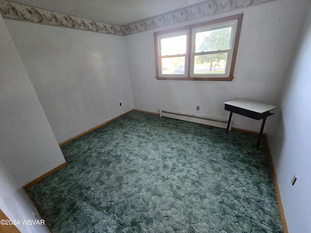 carpeted spare room featuring a textured ceiling and baseboard heating