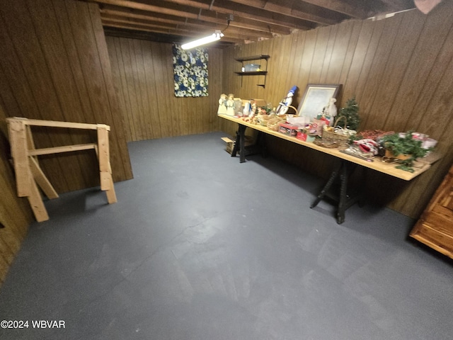 basement featuring wood walls