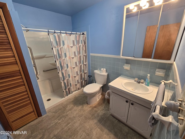 bathroom with toilet, vanity, tile walls, and walk in shower