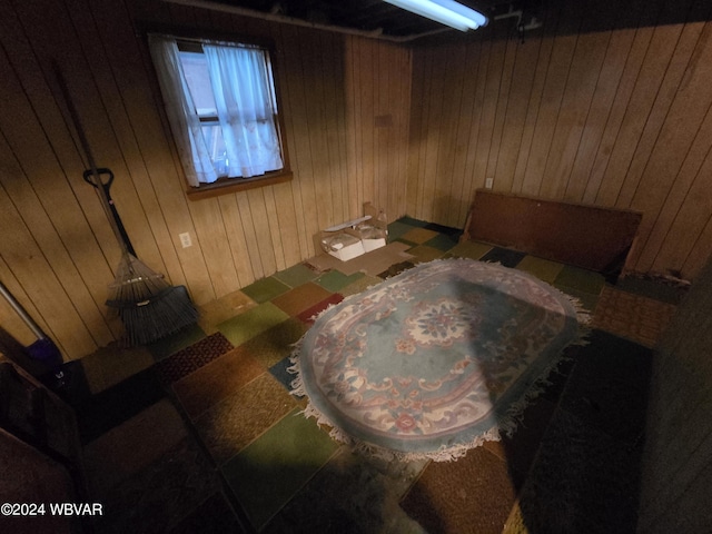 bedroom featuring wooden walls