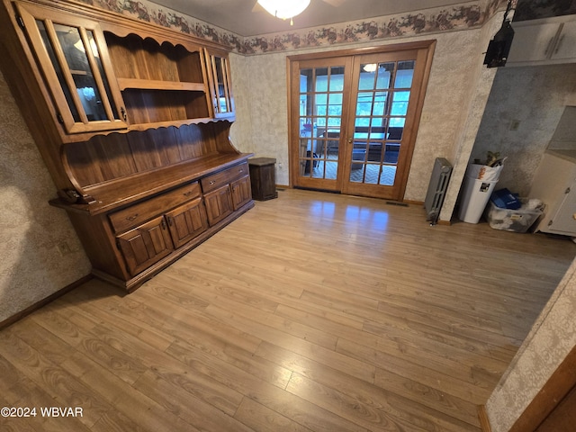 interior space with french doors and light hardwood / wood-style flooring