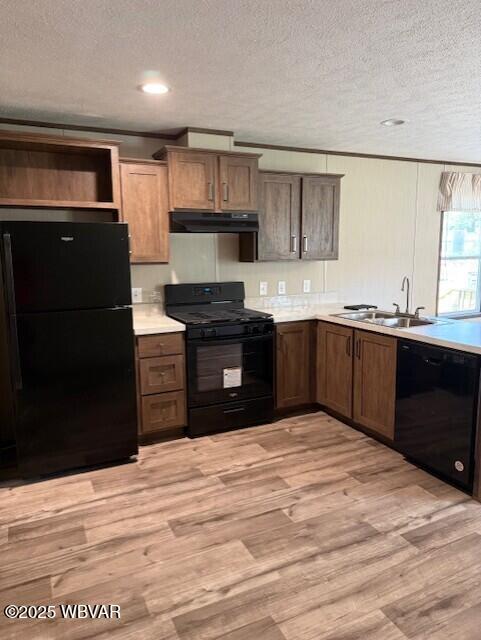 2381 Rt 405th Hwy, Muncy, PA 17756 - kitchen featuring black appliances, under cabinet range hood, a textured ceiling, light wood-style flooring, and light countertops