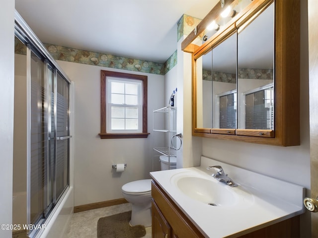 full bathroom featuring combined bath / shower with glass door, vanity, and toilet