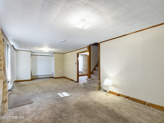 carpeted spare room featuring ornamental molding