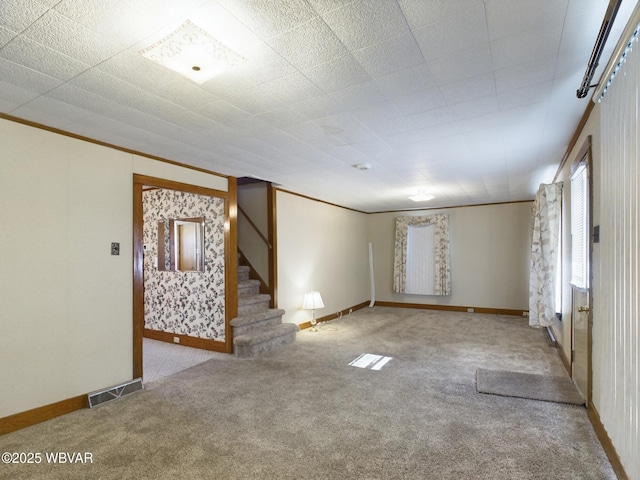 empty room with crown molding and light carpet