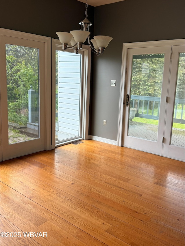 1290 Windfield Dr, Williamsport, PA 17701 - unfurnished dining area with light wood-type flooring and a chandelier