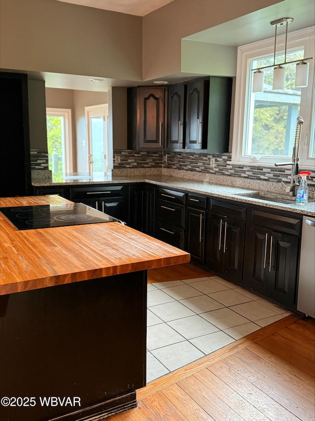 1290 Windfield Dr, Williamsport, PA 17701 - kitchen with wooden counters, decorative backsplash, stovetop, and a sink