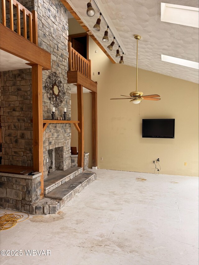 1290 Windfield Dr, Williamsport, PA 17701 - unfurnished living room with ceiling fan, a stone fireplace, and vaulted ceiling