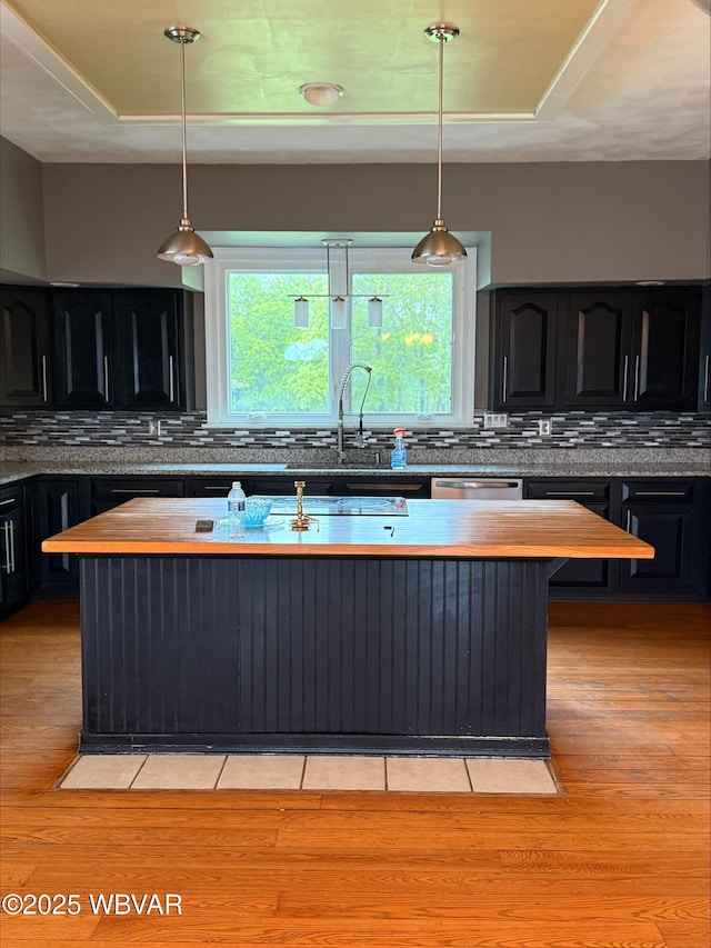 1290 Windfield Dr, Williamsport, PA 17701 - kitchen featuring a sink, stainless steel dishwasher, decorative backsplash, and light wood finished floors