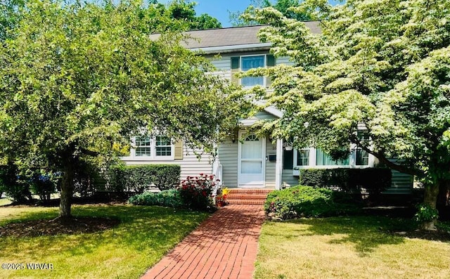 obstructed view of property with a front lawn