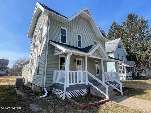 view of front of house with a porch and central AC