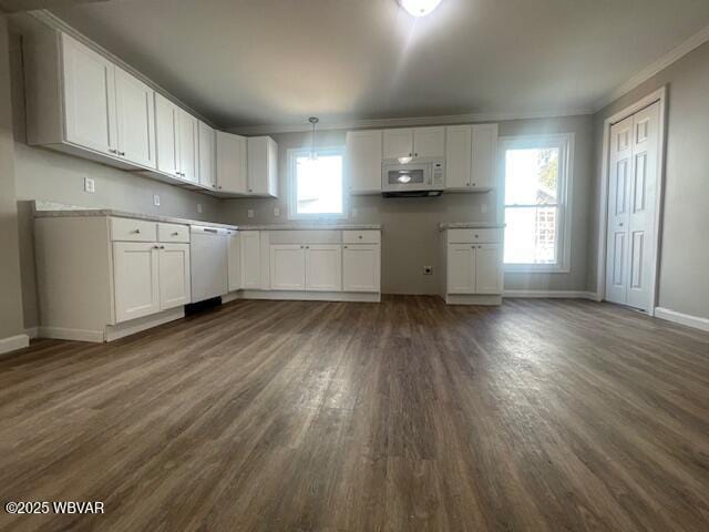 kitchen featuring white appliances, white cabinets, baseboards, dark wood-style flooring, and hanging light fixtures