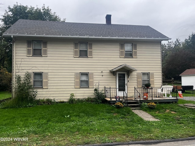 26 E Village Dr, Williamsport, PA 17702 - view of front of home with a front yard, a wooden deck, a shingled roof, and a chimney