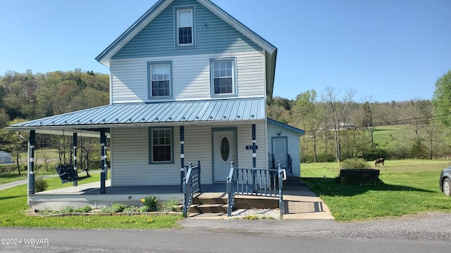 view of front facade with covered porch and a front lawn