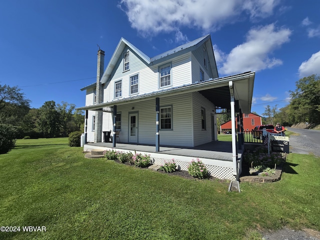 farmhouse-style home with covered porch and a front yard