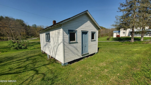 view of outdoor structure with a lawn