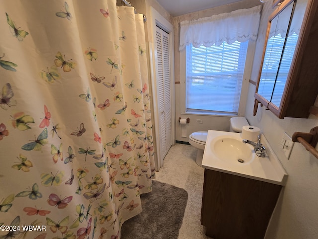 bathroom featuring vanity, toilet, and walk in shower