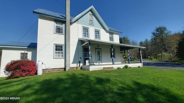 exterior space with a porch and a lawn