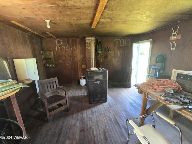 living area with dark hardwood / wood-style floors, wooden ceiling, and wood walls