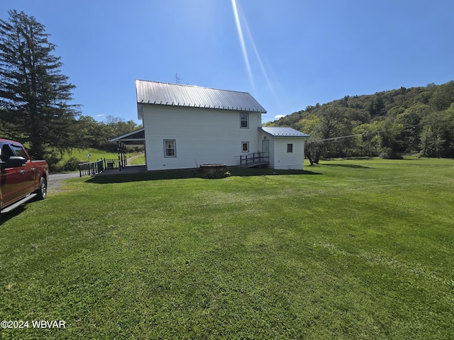 view of property exterior with a lawn