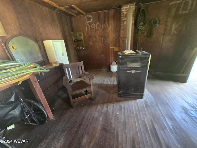 sitting room featuring dark hardwood / wood-style floors and wooden walls