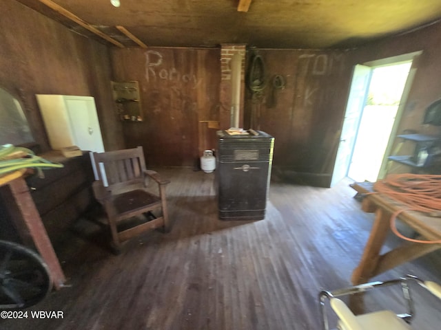 misc room featuring dark hardwood / wood-style flooring and wooden walls