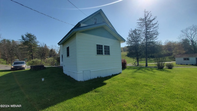 view of side of home with a lawn