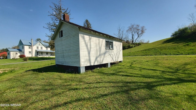 view of side of property with a lawn