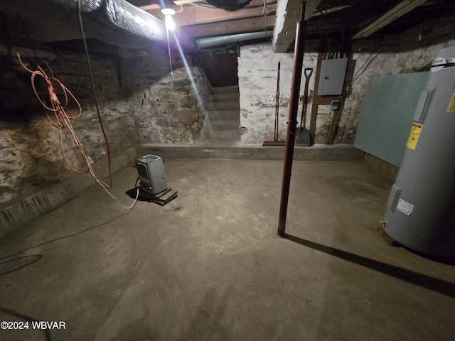 basement featuring electric water heater and electric panel