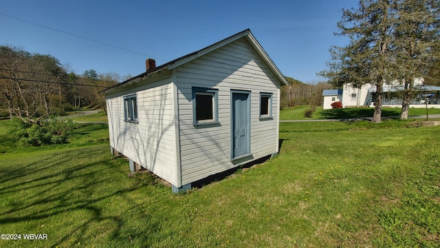 view of outdoor structure with a lawn