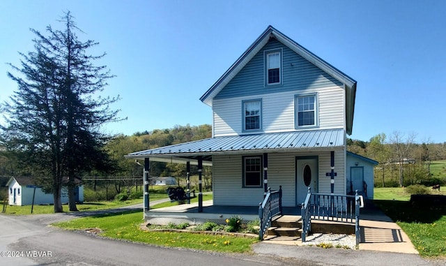 view of front of house featuring covered porch and a front lawn