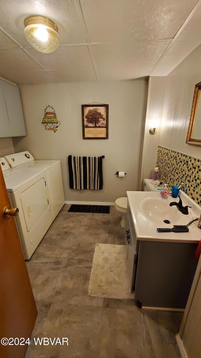 bathroom with vanity, toilet, and separate washer and dryer