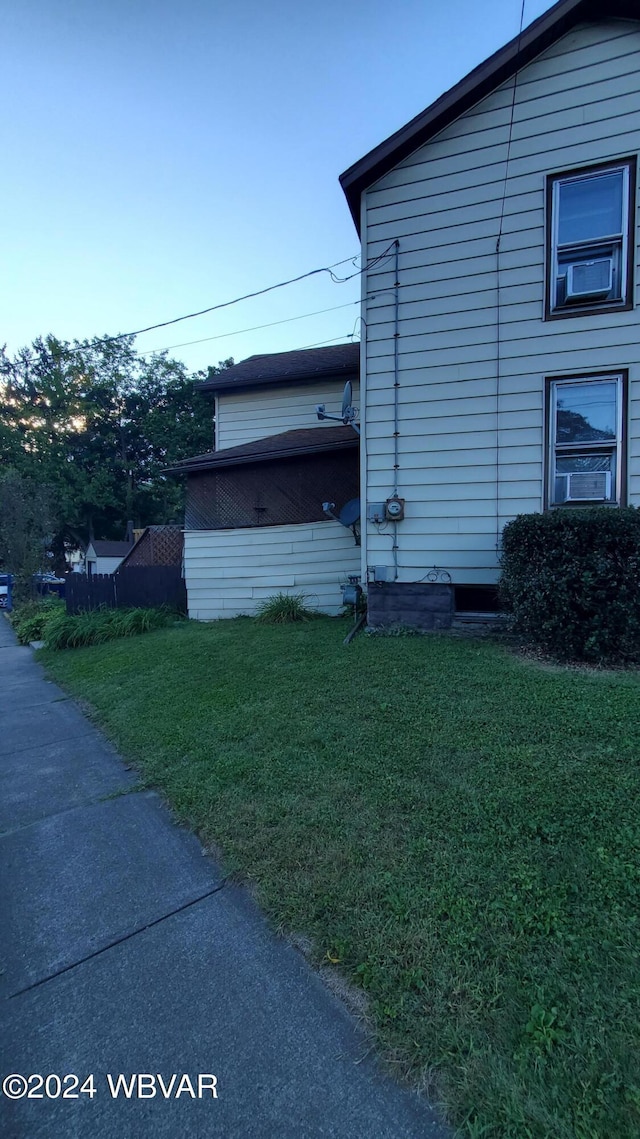 view of side of property with a yard