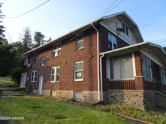 view of side of home with a lawn