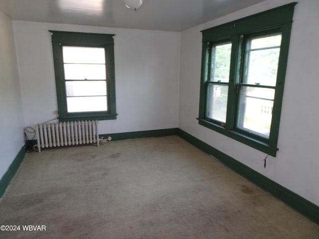 carpeted spare room with radiator