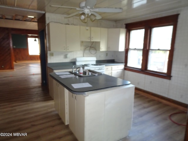 5047 Blockhouse Rd, Liberty, PA 16930 - kitchen with wood finished floors, a ceiling fan, white range with gas cooktop, white cabinets, and wood walls