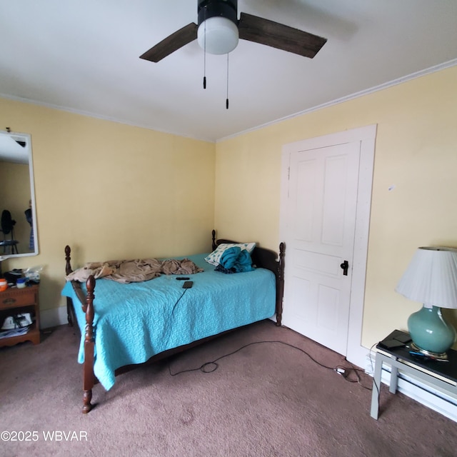 bedroom with crown molding, ceiling fan, and carpet floors